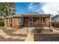 Charming brick home featuring a covered front porch and well-maintained landscaping at 1386 S Garfield St, Denver, CO 80210