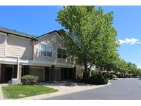 Townhome with attached garage, manicured lawn and lush tree at 1652 Egret Way, Superior, CO 80027