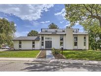 Charming two-story home with modern architecture, manicured lawn, and brick chimney at 7792 Garrison Ct, Arvada, CO 80005