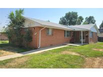 Charming single-story brick home with a well-manicured lawn and inviting walkway at 117 Valentine Ln, Longmont, CO 80501