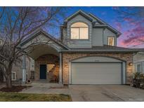 Charming two-story home featuring a stone facade, covered entrance, and attached two-car garage at 6657 Drew Ranch Ln, Boulder, CO 80301