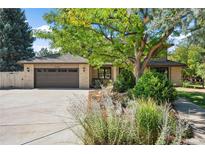 Brick home with a two-car garage and mature landscaping at 5178 W Lake Pl, Littleton, CO 80123