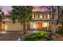 Charming two-story home with brick accents, mature trees, and a well-manicured lawn at 5556 S Sedalia St, Centennial, CO 80015