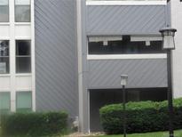 The apartment building with gray siding and trimmed bushes at 9887 E Peakview Ave # F06, Englewood, CO 80111