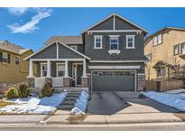 Charming two-story home with stone accents, covered porch, and attached two-car garage at 10935 Valleybrook Cir, Highlands Ranch, CO 80130