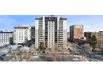 High-rise apartment building with a parking lot and city views, set against a bright blue sky at 2 Adams St # 608, Denver, CO 80206