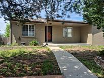 Charming single story brick home with front porch and walkway at 2043 S Salida St, Aurora, CO 80013