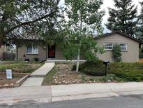 Charming single-story home featuring a brick exterior and a neatly landscaped front yard at 2043 S Salida St, Aurora, CO 80013