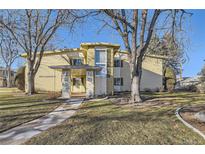 Inviting exterior view of a home with mature trees and a well-manicured lawn on a sunny day at 735 S Clinton St # 5B, Denver, CO 80247