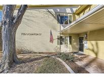 Charming home featuring classic architecture, decorative shutters, and an American flag at 735 S Clinton St # 5B, Denver, CO 80247