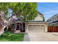 Charming home featuring a two-car garage, inviting porch, and beautiful landscaping at 1089 E 131St Dr, Thornton, CO 80241