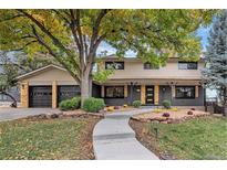 Inviting two-story home boasting a charming front yard, a large shade tree and a two car garage at 5720 E Caley Ave, Centennial, CO 80111