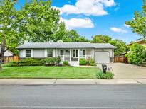 Charming single-story home featuring a well-manicured lawn and attached one car garage at 6943 Ingalls St, Arvada, CO 80003