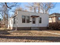A single-story home with horizontal siding and a small front yard covered in fallen leaves at 367 S Jasmine St, Denver, CO 80224