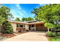 Charming single-story home boasts a well-maintained front yard, covered entry and attached two car garage at 11496 E Wesley Ave, Aurora, CO 80014