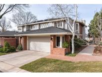 Charming two-story home featuring a brick facade, attached garage, and well-maintained landscaping at 2552 E Alameda Ave # 47, Denver, CO 80209