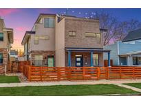 Modern two story home features a brick facade, a quaint front yard, and a wooden fence for added privacy at 3720 Jason St, Denver, CO 80211