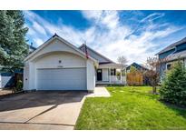 Charming single-Gathering home with attached garage, green lawn, and inviting curb appeal at 21743 Farmingdale Ct, Parker, CO 80138