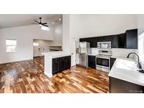 Modern kitchen with stainless steel appliances, white countertops and dark cabinets at 21743 Farmingdale Ct, Parker, CO 80138