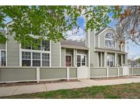 Charming townhome with large windows and a well-maintained front exterior at 5875 W Asbury Pl, Lakewood, CO 80227