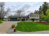 Charming home featuring a well-manicured lawn and an attached two-car garage, great curb appeal at 11310 W Center Ave, Lakewood, CO 80226