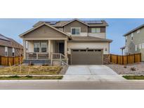 Charming two-story home with a two-car garage, solar panels, a front porch, and a well-manicured lawn at 17786 Olive St, Broomfield, CO 80023