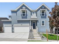Charming two-story home with a two-car garage, modern siding, and a welcoming entryway at 16565 Black Rose Cir, Parker, CO 80134