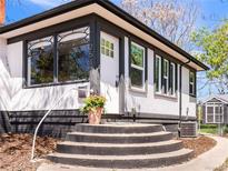 Charming home featuring a welcoming entrance with bright white trim and a black accent base at 2517 W 44Th Ave, Denver, CO 80211