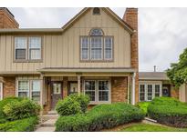 Charming townhouse with brick accents, well-maintained landscaping, and covered front entry at 9672 W Chatfield Ave # C, Littleton, CO 80128