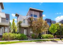 Stunning modern home featuring a two-story design, balcony, professional landscaping, and neutral color palette at 8774 Martin Luther King Blvd, Denver, CO 80238