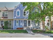 Charming townhome featuring a well-kept lawn and beautiful mature trees, offering great curb appeal at 9771 W Cornell Pl, Lakewood, CO 80227