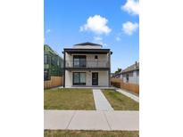 Modern two-story home featuring a white brick facade, balconies, and a well-maintained lawn at 3711 Pecos St, Denver, CO 80211