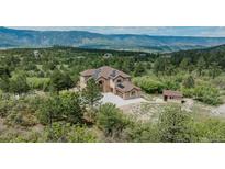 Beautiful home with solar panels nestled among the trees with stunning mountain views at 8403 Homestake Ct, Larkspur, CO 80118