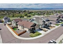 Charming, suburban homes with manicured lawns in a neighborhood surrounded by beautiful mountain views at 4090 Forever Cir, Castle Rock, CO 80109