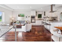 Bright open-concept living room and kitchen with hardwood floors and modern appliances at 2945 E 26Th Avenue Pkwy, Denver, CO 80205