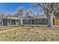 Charming home with a well-maintained lawn, a cozy carport, and a classic red front door at 3164 S Forest St, Denver, CO 80222
