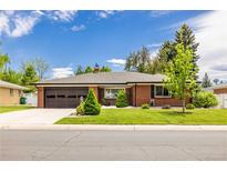 Charming brick ranch-style home featuring a well-manicured lawn, a two-car garage, and mature trees at 428 W Valleyview Ave, Littleton, CO 80120