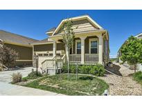 Charming single-Gathering home featuring a covered front porch and a well-manicured lawn at 15347 Quince Cir, Thornton, CO 80602