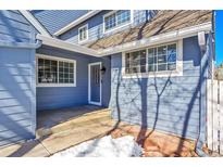 Inviting front entrance of a charming home with blue siding and well-maintained landscaping at 10626 W Park Mtn, Littleton, CO 80127