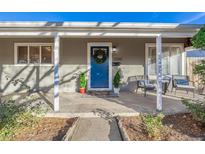 Inviting front porch with blue door and comfortable seating at 3200 S Grape St, Denver, CO 80222