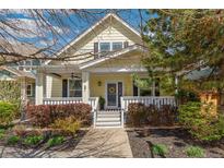 Charming yellow home with a welcoming front porch and well-maintained landscaping at 8865 E 28Th Ave, Denver, CO 80238