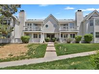 Inviting two-story condo building with balconies and well-maintained front lawn at 12625 E Pacific Cir # E, Aurora, CO 80014