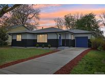 Charming home with a blue door and garage in front of a beautiful lawn and inviting driveway at 7780 Osceola St, Westminster, CO 80030