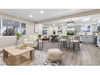 Bright living room with open floor plan, modern furniture, and stylish decor for comfortable living at 7481 W 73Rd Pl, Arvada, CO 80003