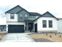 Modern two-story home featuring white siding, black trim, and a two-car garage at 39836 Floyd St, Elizabeth, CO 80107