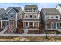 Charming two-story home with a cozy front porch and balcony, perfect for relaxing outdoors at 11346 E 27Th Ave, Denver, CO 80238