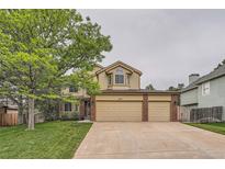 Charming two-story home with a large tree and a spacious three-car garage at 11522 Pine Grove Ln, Parker, CO 80138