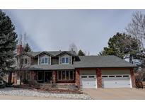 Charming two-story home with a well-manicured front yard and a brick and siding facade at 8057 S Leyden St, Centennial, CO 80112