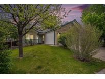 Charming single-Gathering home featuring a well-maintained lawn and mature trees in a peaceful neighborhood at 5214 S Tibet St, Aurora, CO 80015