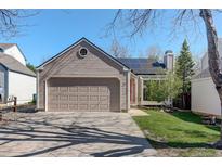 Charming home featuring a two-car garage, solar panels, and a well-maintained front yard at 291 W Sycamore Ln, Louisville, CO 80027